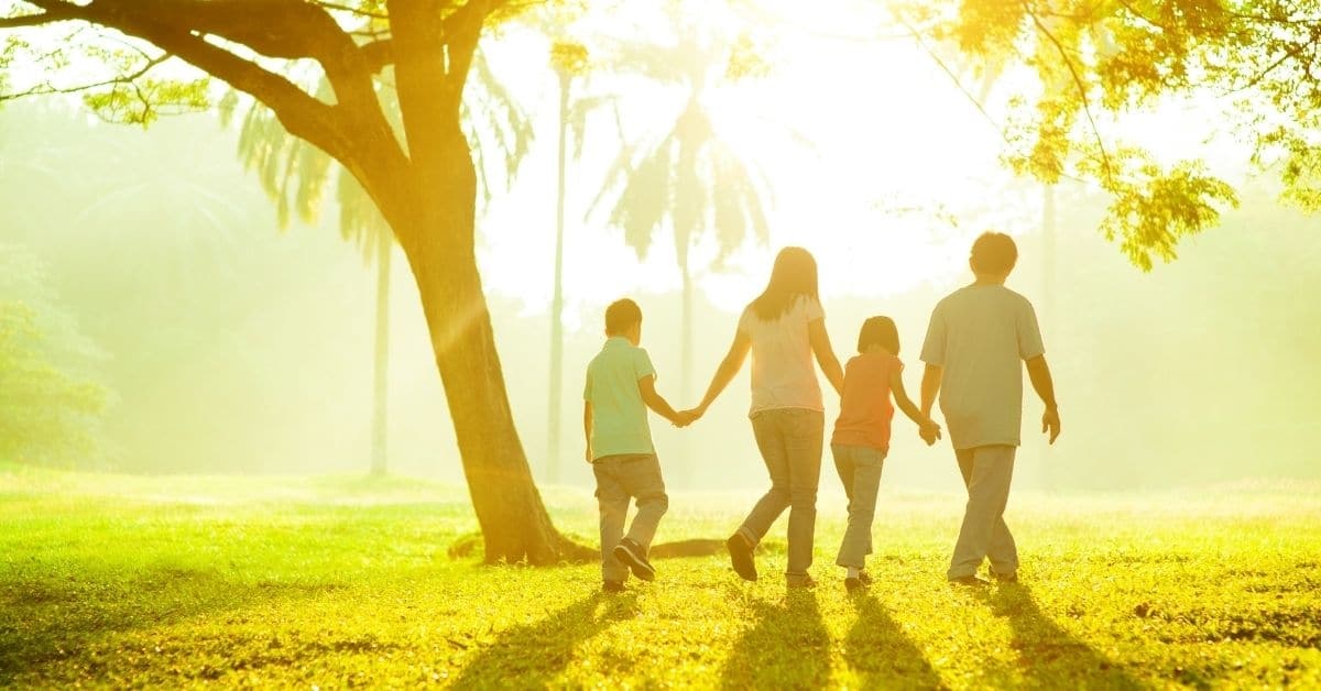 family walking in the sunshine